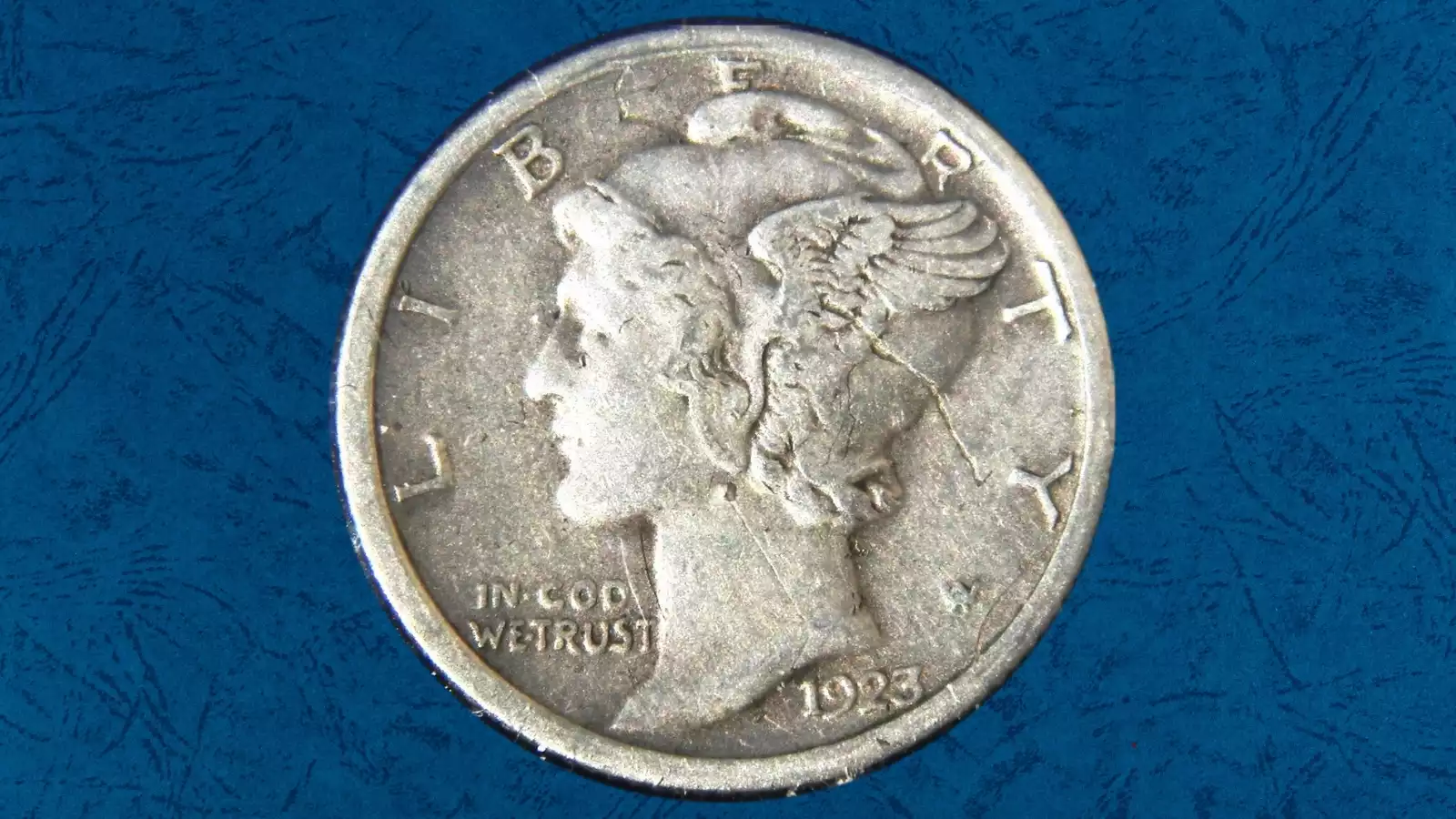 1923 Mercury dime struck-through error showing missing or filled design area from grease or debris between the dies